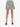 A short, pleated skirt with a black and white spotted pattern, paired with open-toed black heels.