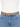 A tan belt with a gold buckle worn over a white top and blue denim jeans.
