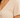 Close-up of a light beige top featuring a deep V-neck and gathered detailing at the front.
