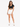 A woman stands confidently in a black cropped top and white high-waisted shorts, paired with white sneakers.