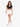 A model walks confidently in a black cropped top and white shorts, paired with white sneakers.