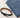 A black leather belt with a silver buckle placed beside folded blue denim jeans on a light fabric surface.