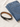 A black leather belt with a silver buckle placed beside folded blue denim jeans on a light fabric surface.