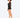 A model poses in a sheer long-sleeve top and high-waisted shorts, paired with strappy black heels.