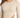 Close-up of a model wearing a ribbed long-sleeve bodysuit with a side cutout in a neutral beige color.