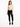 A model poses in a fitted long-sleeve top with cut-out details, paired with black skinny jeans and sneakers.
