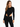 A model poses in a black ribbed bodysuit with long sleeves and cut-out sides, paired with black jeans.