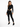 A model wearing a black ribbed bodysuit with cut-out sides, paired with black skinny jeans and sneakers.