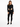 A model wearing a black long-sleeve bodysuit with cut-out sides, paired with black skinny jeans and sneakers.