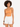 A model with curly hair wears an orange bodysuit with a cutout, paired with white high-waisted shorts.