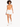 A model with curly hair wears an orange bodysuit and white shorts, walking in white sneakers against a light background.
