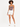 A model wearing a fitted bodysuit with a cutout design, paired with white shorts and sneakers.