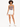 Model wearing a fitted bodysuit with a cutout detail, paired with white shorts and sneakers.