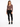 A model poses in a fitted long-sleeve top with a V-neck and cut-out details, paired with black skinny jeans and sneak...
