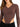 A fitted brown long-sleeve top with a V-neck and cut-out sides, paired with black high-waisted pants.