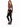 A model poses in a fitted long-sleeve top with a cutout design, paired with black skinny jeans and sneakers.