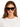 A woman wearing oversized black sunglasses with a tortoiseshell pattern, styled with loose, wavy hair.