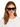 A woman with long, wavy hair wears oversized black sunglasses with a tortoiseshell pattern, paired with a white shirt.