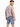 A man wearing a sleeveless shirt and denim shorts, posing with a casual stance and a slight turn.