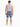 A man stands with his back to the camera, wearing light blue denim shorts and a sleeveless gray top.