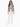A woman wearing a sleeveless denim vest over a green top, paired with light pants and white sneakers.