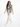 A woman walks confidently in a sleeveless denim vest, paired with a green crop top and light pants.
