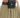 Close-up of olive green pants featuring a textured black belt with a pouch and a decorative silver buckle.