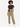 A model wearing loose-fitting olive green pants paired with a black crop top and white sneakers.
