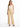 A woman wearing beige high-waisted pants paired with a light tank top and black heeled sandals.
