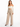 A model wearing high-waisted, beige wide-leg pants paired with a fitted off-the-shoulder top.