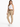 A woman poses in light beige pants, a white crop top, and white sneakers, showcasing a casual outfit.