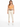A woman stands confidently in light-colored, cropped pants paired with a fitted orange top and a braided brown belt.