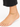 A delicate gold anklet adorned with colorful beads, worn on a bare foot against a white background.