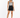 A model with curly hair wears a patterned tank top and high-waisted black shorts, paired with black sneakers.