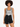 A model with curly hair wears a patterned bodysuit paired with high-waisted black denim shorts.