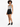 A model poses in a patterned bodysuit and high-waisted black shorts, paired with black sneakers.