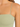 Close-up of a light green ribbed top featuring thin straps and a square neckline, highlighting the fabric texture.