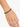 A close-up of a hand wearing a beaded bracelet featuring deep blue and gold accents.