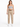 A woman stands confidently in a gray cropped top and beige high-waisted pants, paired with white sneakers.