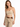 A woman poses in a fitted beige top with thin straps, paired with high-waisted beige trousers and a braided brown belt.