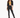 A model poses in a cropped black blazer over a yellow bikini, paired with fitted black pants featuring slits.