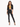 A model poses in a cropped black blazer over a yellow bikini, paired with fitted black pants featuring slits.