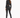 A woman with long hair wears a cropped black jacket and fitted black pants, paired with high-heeled sandals.