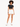 A model poses in a black cropped top and white high-waisted shorts, paired with white sneakers.