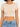 A fitted, short-sleeve top in a light beige color, paired with high-waisted blue denim jeans.