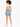 A model with curly hair wears a beige cropped top featuring a back cutout, paired with high-waisted denim shorts.