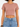 A model wearing a short-sleeve, cropped top in a muted pink color paired with high-waisted denim shorts.