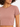 Close-up of a woman wearing a fitted, short-sleeve, dusty rose top with a round neckline.