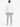 A person wearing a white denim jacket with a shearling collar, paired with gray pants and white sneakers, viewed from...