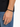 A close-up of a hand wearing a black beaded bracelet, showcasing a simple and modern design.